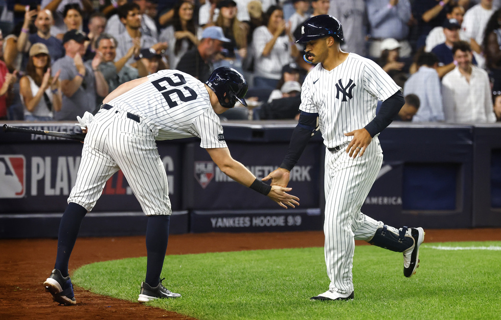 New York Yankees' Ben Rice (22) congratulates Trent Grisham, right, after Grisham hit a home run during the third inning of a baseball game against the Boston Red Sox, Sunday, Aug. 24, 2025, in New York. (AP Photo/Noah K. Murray)
