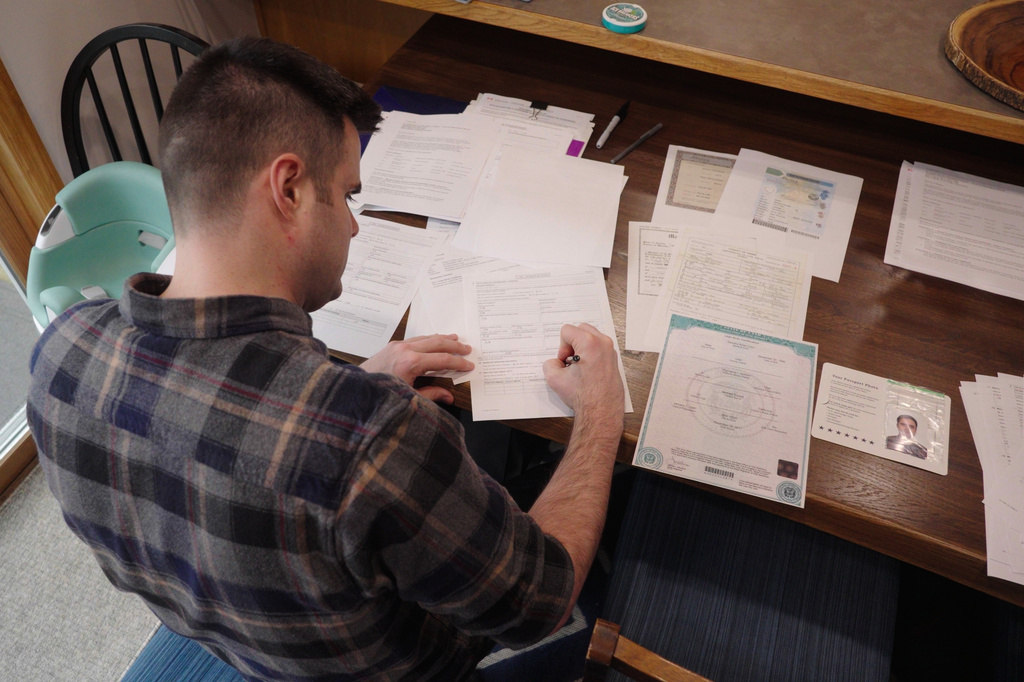 This image made from video shows Zach Loud completing his application for Canadian citizenship at his family's home in Farmington, Minn., April 17, 2026. (AP Photo/Mark Vancleave)
