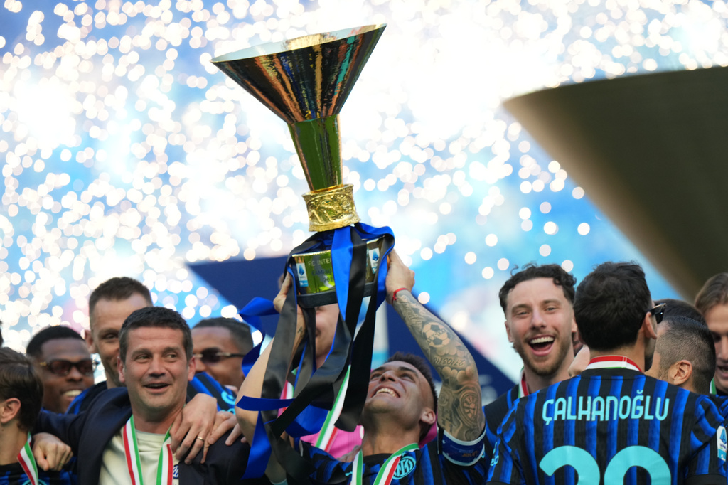Inter Milan players celebrate with the Italian Serie A soccer championship trophy after it was presented to them at the end of their final-round match against Hellas Verona in Milan, Italy, Sunday, May 17, 2026. (AP Photo/Luca Bruno)
