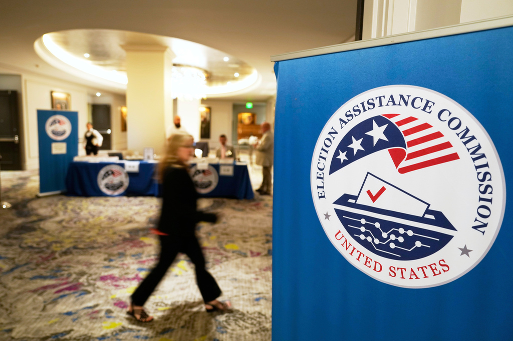 FILE - A meeting goer arrives for a U.S. Election Assistance Commission Standards Board in-person public meeting, April 24, 2025, in Charlotte, N.C. (AP Photo/Chris Carlson, File)