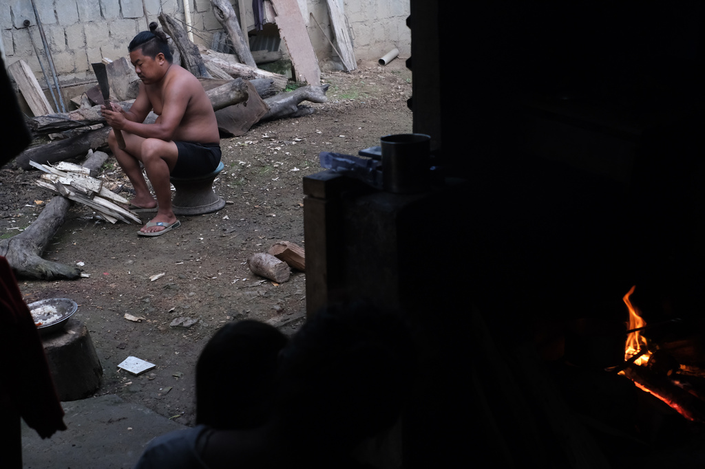 Tovi Murru, 32, chops wood to cook dinner in Kohima, capital of the northeastern Indian state of Nagaland, Monday, July 6, 2026. (AP Photo/Yirmiyan Arthur)