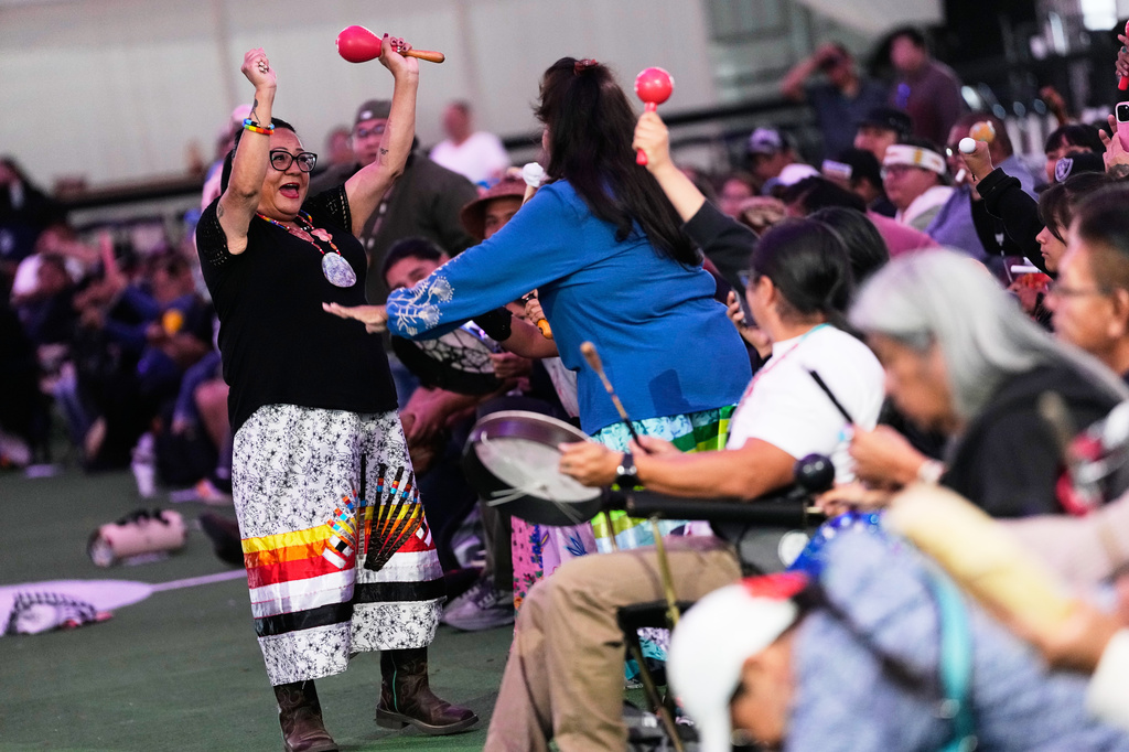 Christina Lomaintewa, facing, celebrates with Angie Lucero after their team won a "material game," a stick game played for objects, before a Stick-Games Tournament hosted by the Puyallup Tribe in partnership with World Cup host city Seattle, Saturday, June 27, 2026, in Tacoma, Wash. (AP Photo/Lindsey Wasson)
