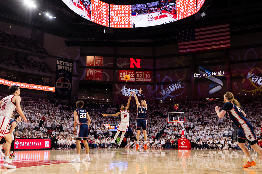 Illinois forward Ben Humrichous (3) shoots a 3-point basket against Nebraska guard Jamarques Lawrence (10) during the second half of an NCAA college basketball game, Sunday, Feb. 1, 2026, in Lincoln, Neb. (AP Photo/Bonnie Ryan)