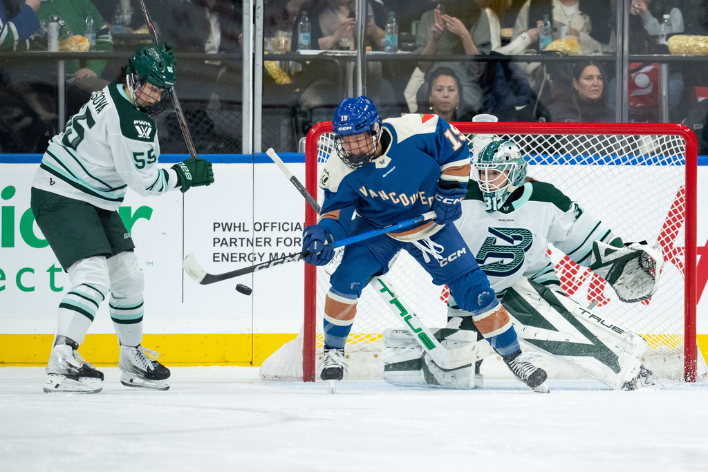 Boston Fleet goaltender Aerin Frankel (31) stops Vancouver Goldeneyes' Mannon McMahon (19) as Boston's Daniela Pejsova (55) watches during the second period of a PWHL game in Vancouver, on Tuesday, March 10, 2026. (Ethan Cairns/The Canadian Press via AP)