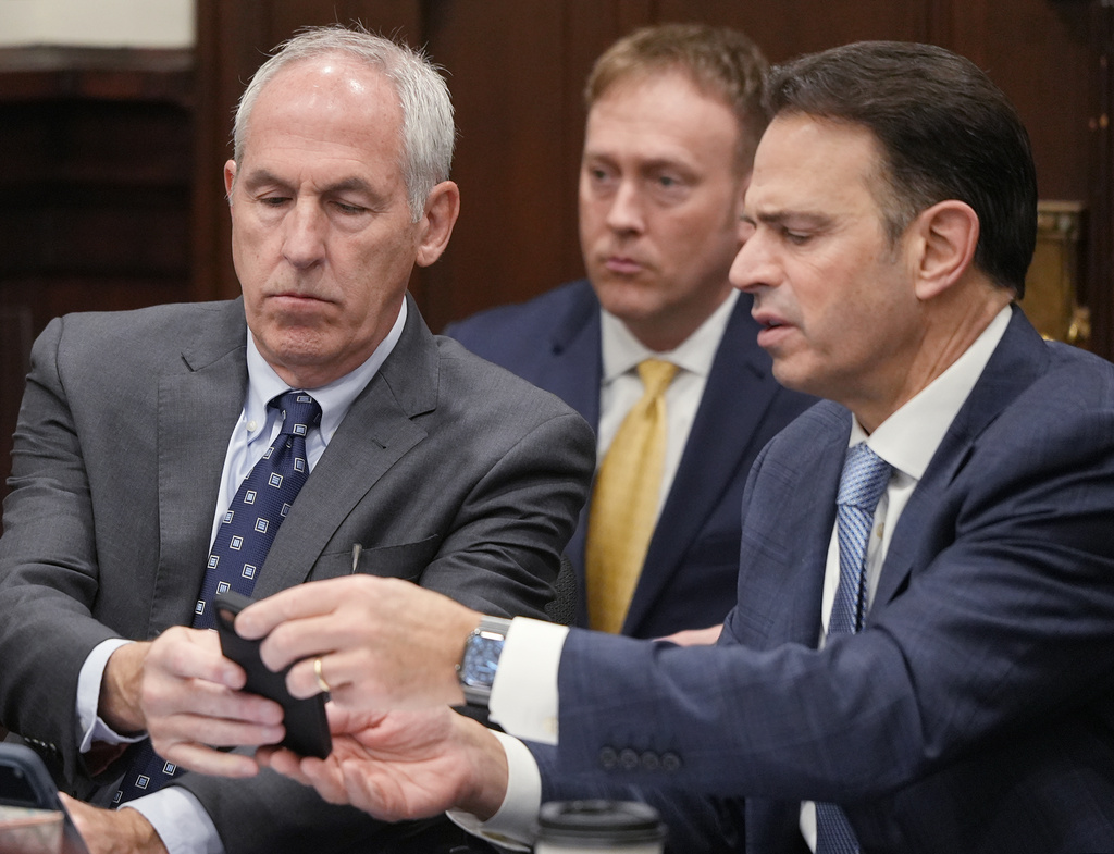 Defendants ex-FirstEnergy Senior Vice President Michael Dowling and defense attorney George Stamboulidis watches a live transcription of an in chamber conference on a jury question in Summit County Common Pleas Judge Susan Baker Ross' courtroom in Akron, Ohio, on Tuesday, March 31, 2026. (Mike Cardew /Akron Beacon Journal via AP, Pool)