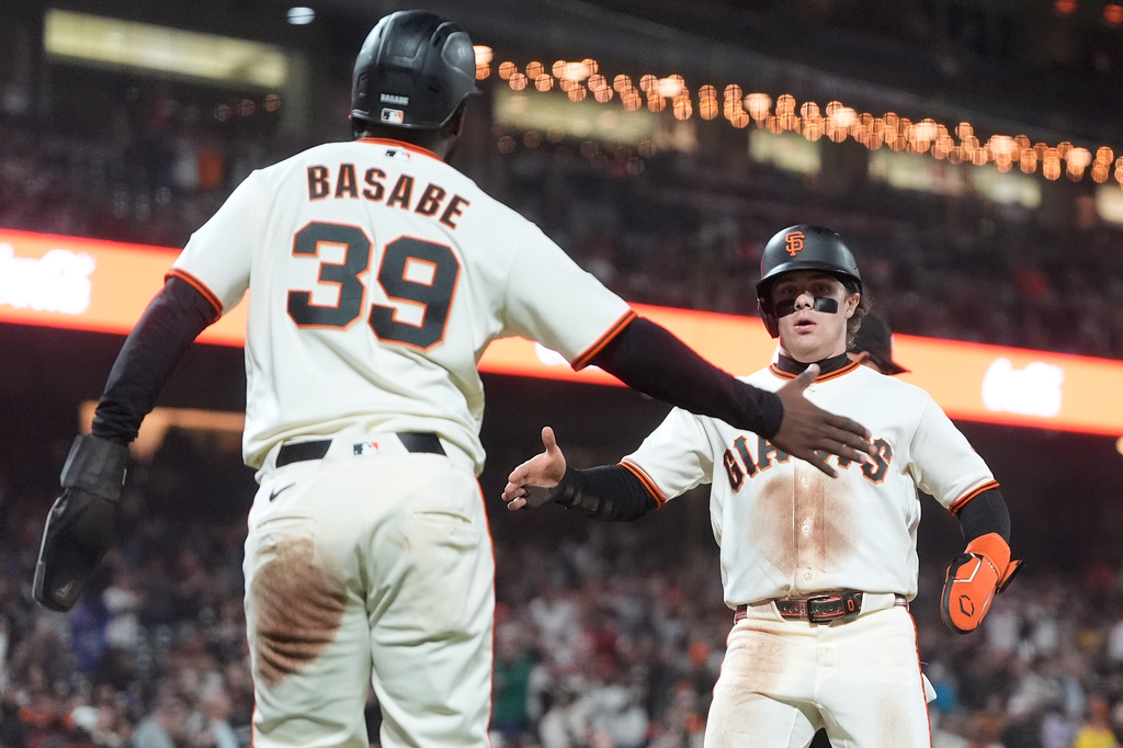 San Francisco Giants' Osleivis Basabe (39) celebrates with Drew Gilbert after both scored on Bryce Eldridge's two-run single against the Arizona Diamondbacks during the fifth inning of the second baseball game of a doubleheader, Saturday, Aug. 29, 2026, in San Francisco. (AP Photo/Jeff Chiu)