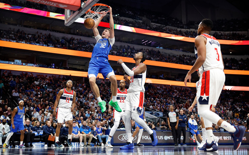 Dallas Mavericks forward Cooper Flagg (32) dunks against Washington Wizards center Alex Sarr (20) during the second quarter of an NBA basketball game Friday, Oct. 24, 2025, in Dallas. (Tom Fox/The Dallas Morning News via AP) Dallas Mavericks forward Cooper Flagg (32) dunks against Washington Wizards center Alex Sarr (20) during the second quarter of an NBA basketball game Friday, Oct. 24, 2025, in Dallas. (Tom Fox/The Dallas Morning News via AP)