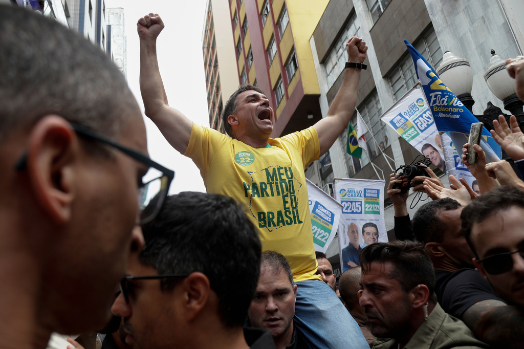 Presidential candidate Flavio Bolsonaro rides on a man's shoulders during his campaign rally at the site where his father, former President Jair Bolsonaro, was injured by a stabbing attack in 2018, in Juiz de Fora, Minas Gerais state, Brazil, Wednesday, Sept. 9, 2026. (AP Photo/Bruna Prado)