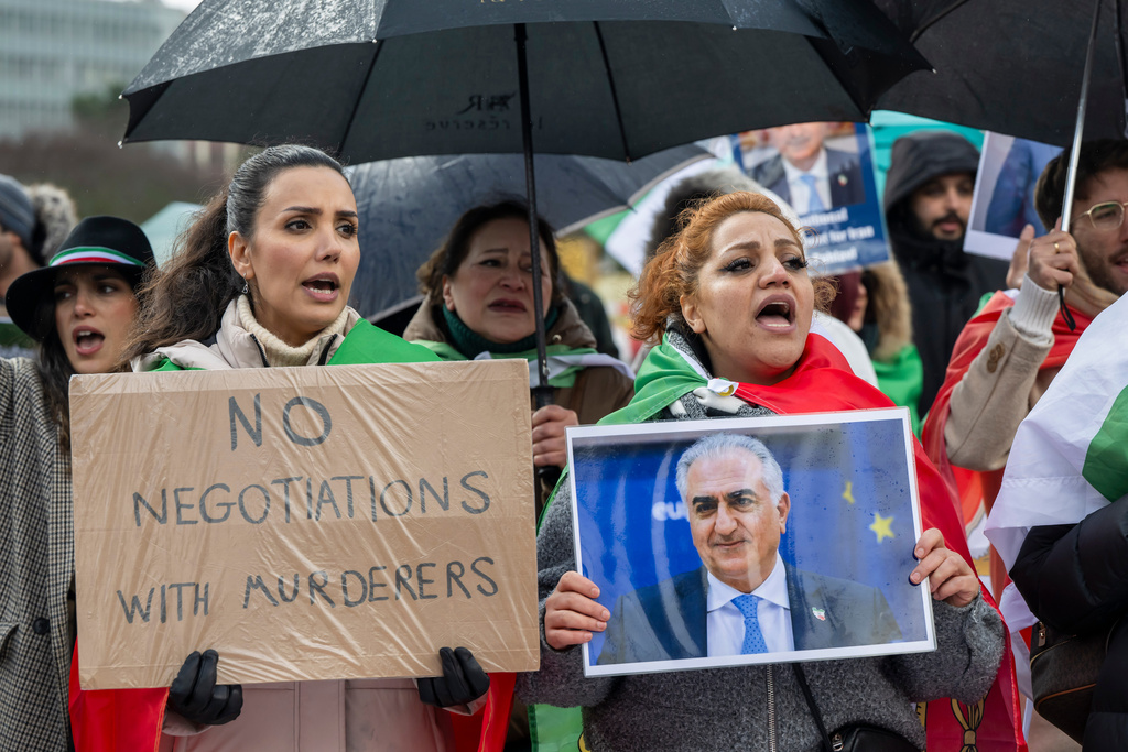Iranian protesters hold placards and portraits as they demonstrate in front of United Nations office ahead of indirect nuclear talks between the United States and Iran in Geneva, Switzerland, Tuesday, Feb. 17, 2026. (Martial Trezzini/Keystone via AP)