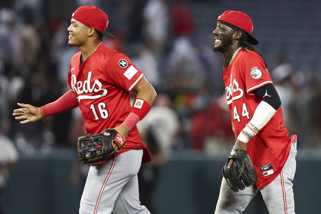 Cincinnati Reds shortstop Elly De La Cruz (44) reacts alongside right fielder Noelvi Marte (16) after the Reds defeat the Angels in a baseball game, Monday, Aug. 18, 2025, in Anaheim, Calif. (AP Photo/Jessie Alcheh)