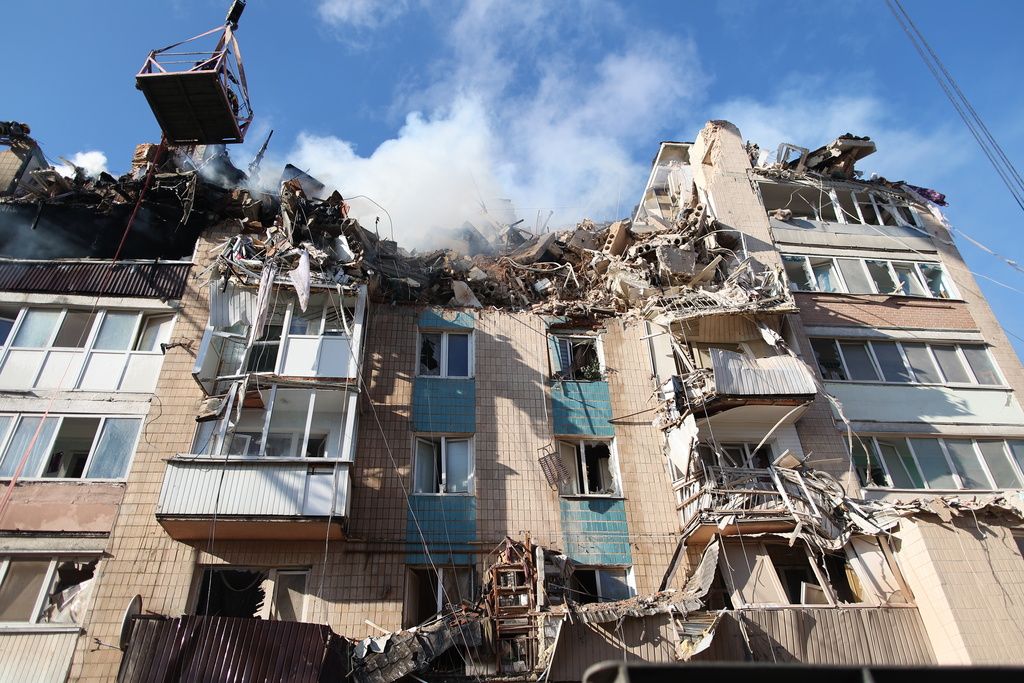 Rescue workers clear the rubble of a residential building which was heavily damaged by a Russian strike on Ternopil, Ukraine, on Wednesday, Nov. 19, 2025. (AP Photo/Vlad Kravchuk)