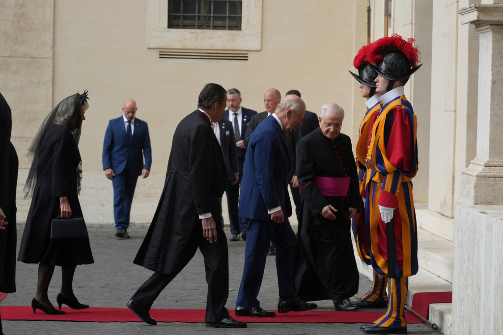 Britain's King Charles III and Queen Camilla arrive in the St. Damasus Courtyard at the Vatican for a state visit, where they will meet with Pope Leo XIV and pray with him in the Sistine Chapel, Thursday, Oct. 23, 2025. (AP Photo/Andrew Medichini)