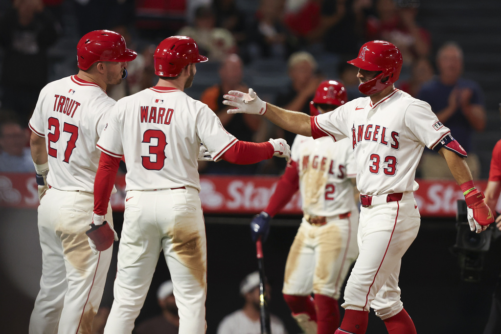 Los Angeles Angels' Chris Taylor (33) celebrates with Taylor Ward (3) designated hitter Mike Trout (27) after hitting a home run during the sixth inning of a baseball game against the Minnesota Twins, Tuesday, Sept. 9, 2025, in Anaheim, Calif. (AP Photo/Jessie Alcheh)