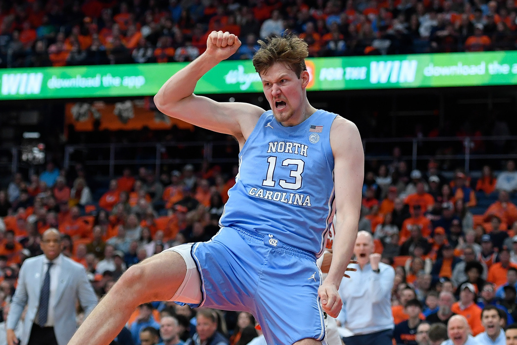 North Carolina center Henri Veesaar (13) reacts after a dunk during the second half of an NCAA college basketball game against Syracuse, Saturday, Feb. 21, 2026, in Syracuse, N.Y. (AP Photo/Adrian Kraus)