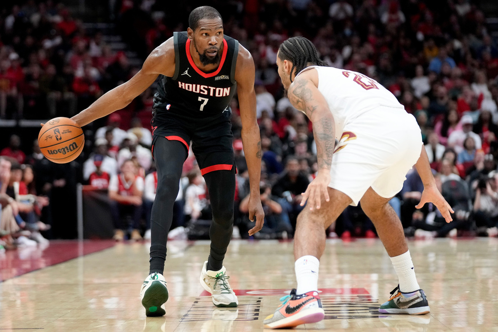 Houston Rockets forward Kevin Durant (7) dribbles as Cleveland Cavaliers guard Jaylon Tyson defends during the first half of an NBA basketball game, Saturday, Dec. 27, 2025, in Houston. (AP Photo/Eric Christian Smith)