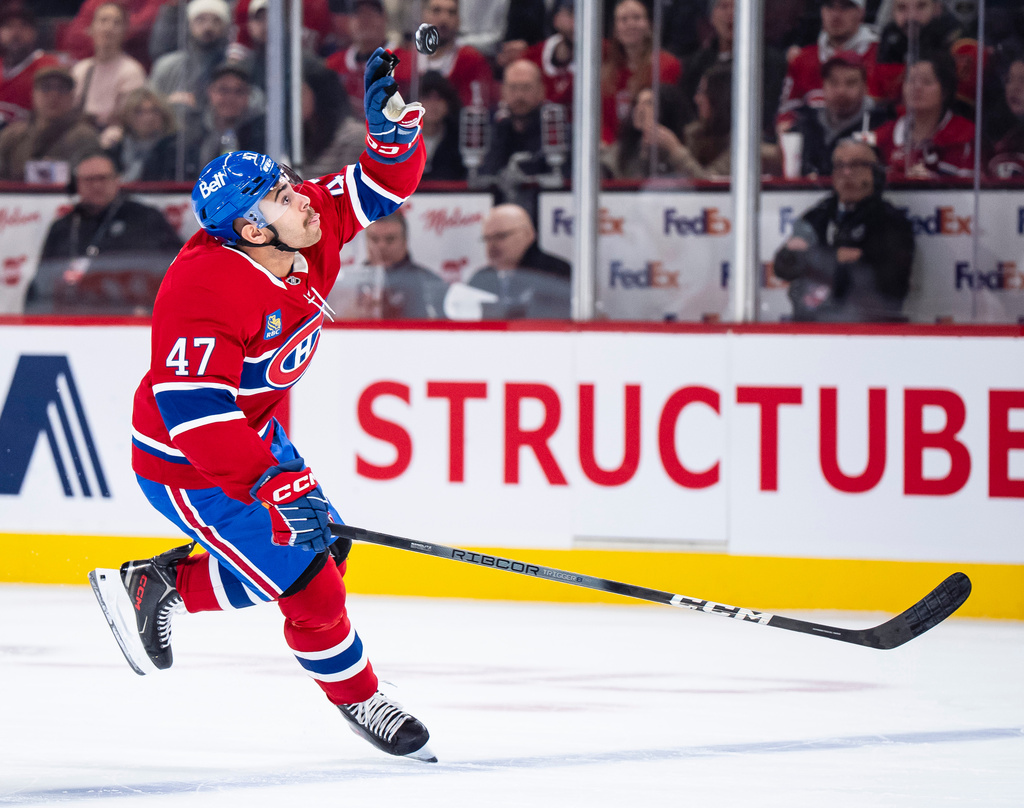 Montreal Canadiens' Jayden Struble catches the puck with his hand during the first period NHL hockey game against the Ottawa Senators in Montreal, Tuesday, Dec. 2, 2025. (Christopher Katsarov/The Canadian Press via AP)