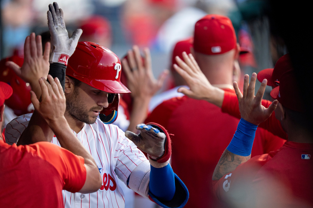 Philadelphia Phillies' Trea Turner, left, celebrates his two-run home run with teammates in the dugout during the second inning of a baseball game against the Los Angeles Dodgers, Monday, July 20, 2026, in Philadelphia. (AP Photo/Chris Szagola)