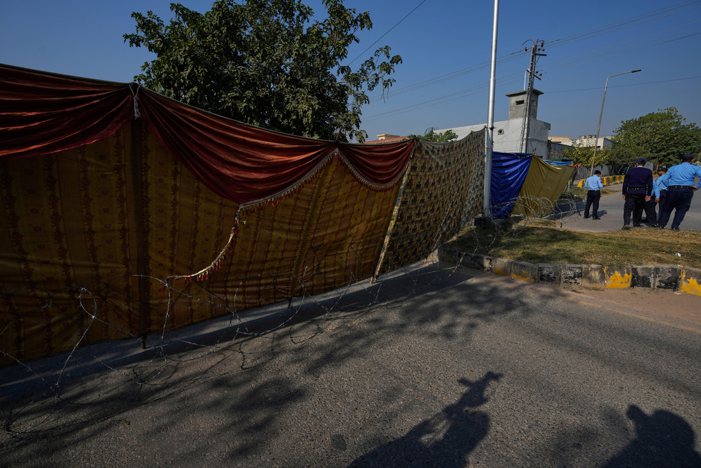 Police personnel stand guard at a cordoned-off road near the site of Tuesday's suicide bombing outside the gates of a district court, in Islamabad, Pakistan, Wednesday, Nov. 12, 2025. (AP Photo/Anjum Naveed)