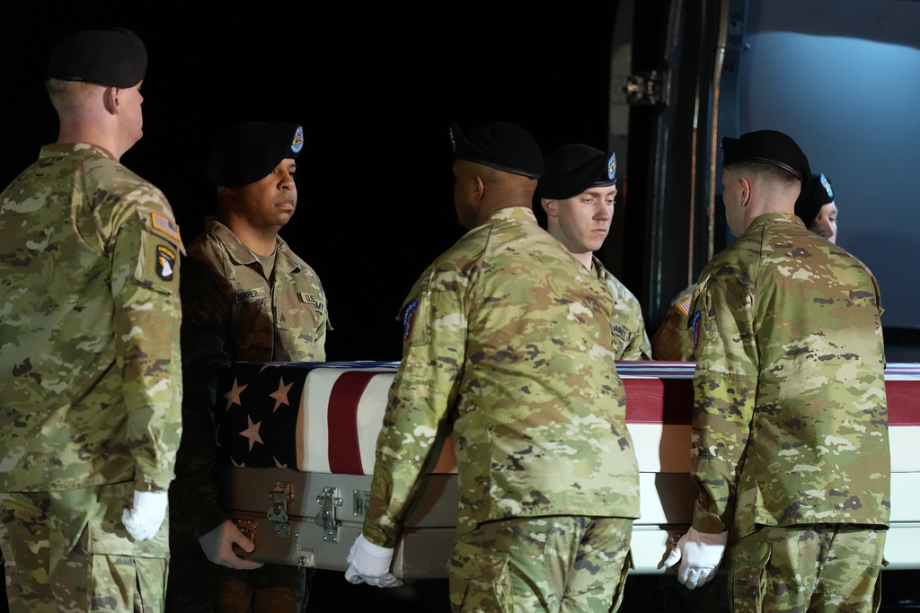 A U.S. Army carry team places the transfer case with the remains of U.S. Army Sgt. Benjamin N. Pennington, 26, of Glendale, Ky., the seventh U.S. service member to die in combat during the Iran war, in the the transfer vehicle during a dignified transfer Monday, March 9, 2026, at Dover Air Force Base, Del. (AP Photo/Julia Demaree Nikhinson)