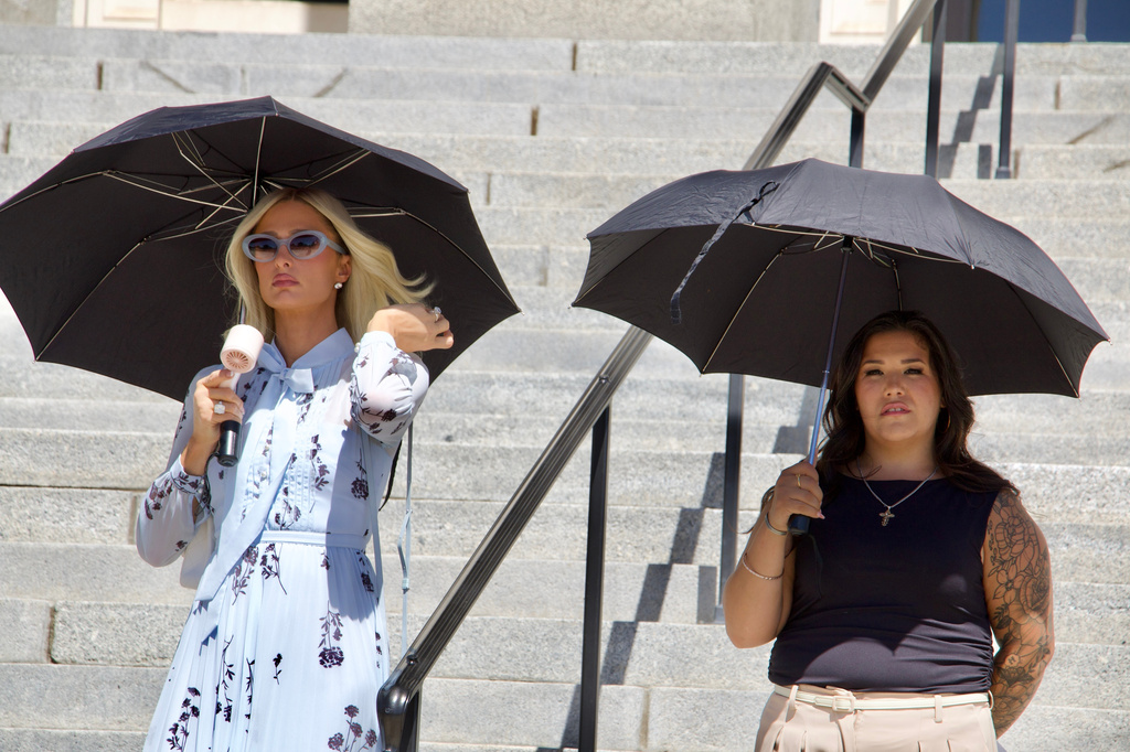 Paris Hilton, left, stands alongside Aleah Corona, the mother of a student injured at the Provo Canyon School, during a news conference Monday, June 15, 2026, in Provo, Utah. (AP Photo/Hannah Schoenbaum)