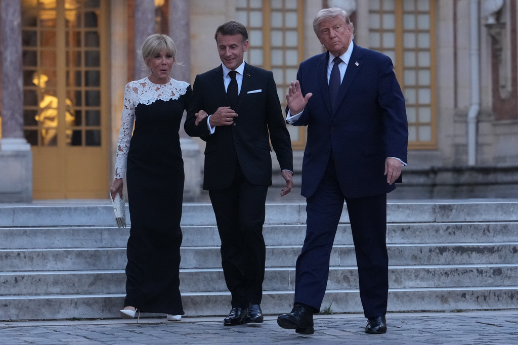 U.S. President Donald Trump is greeted by French President Emmanuel Macron and first lady Brigitte Macron as he arrives at the Palace of Versailles, Wednesday, June 17, 2026, in Versailles, France. (AP Photo/Julia Demaree Nikhinson)