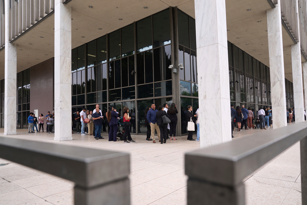 FILE - People line up outside the Los Angeles Federal Building in Los Angeles on Wednesday, June 25, 2025. (AP Photo/Damian Dovarganes, File)