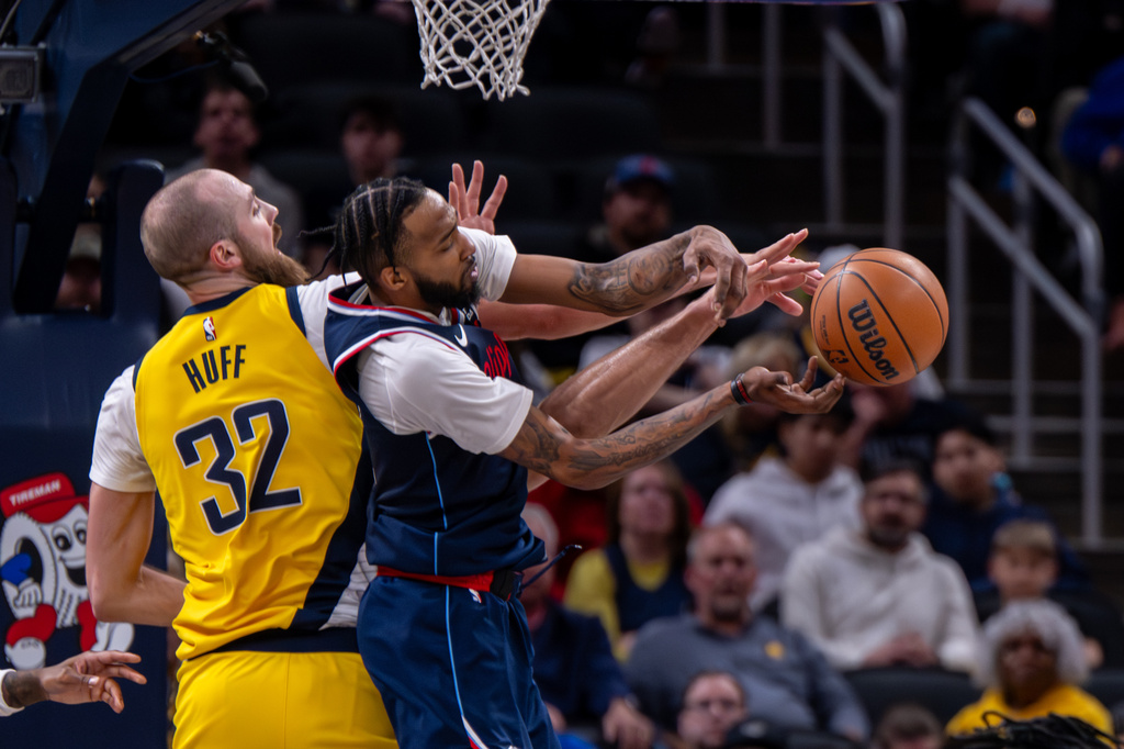 Indiana Pacers center Jay Huff (32) and Los Angeles Clippers forward Derrick Jones Jr., right, battle for a rebound during the first half of an NBA basketball game in Indianapolis, Friday, March 27, 2026. (AP Photo/Doug McSchooler)