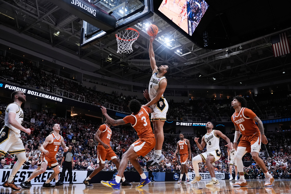 Purdue forward Trey Kaufman-Renn (4) tips the ball over Texas forward Dailyn Swain (3) for the game-winning basket during the second half in the Sweet 16 of the NCAA college basketball tournament, Thursday, March 26, 2026, in San Jose, Calif. (AP Photo/Godofredo A. Vásquez)