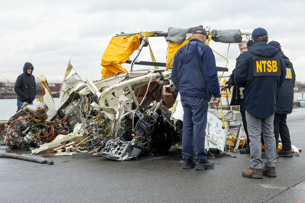 FILE - In this image released by the National Transportation Safety Board, an NTSB team surveys the wreckage Recovered from the helicopter that crashed into Hudson River, April 11, 2025, in Jersey City, N.J. (NTSB via AP, File)