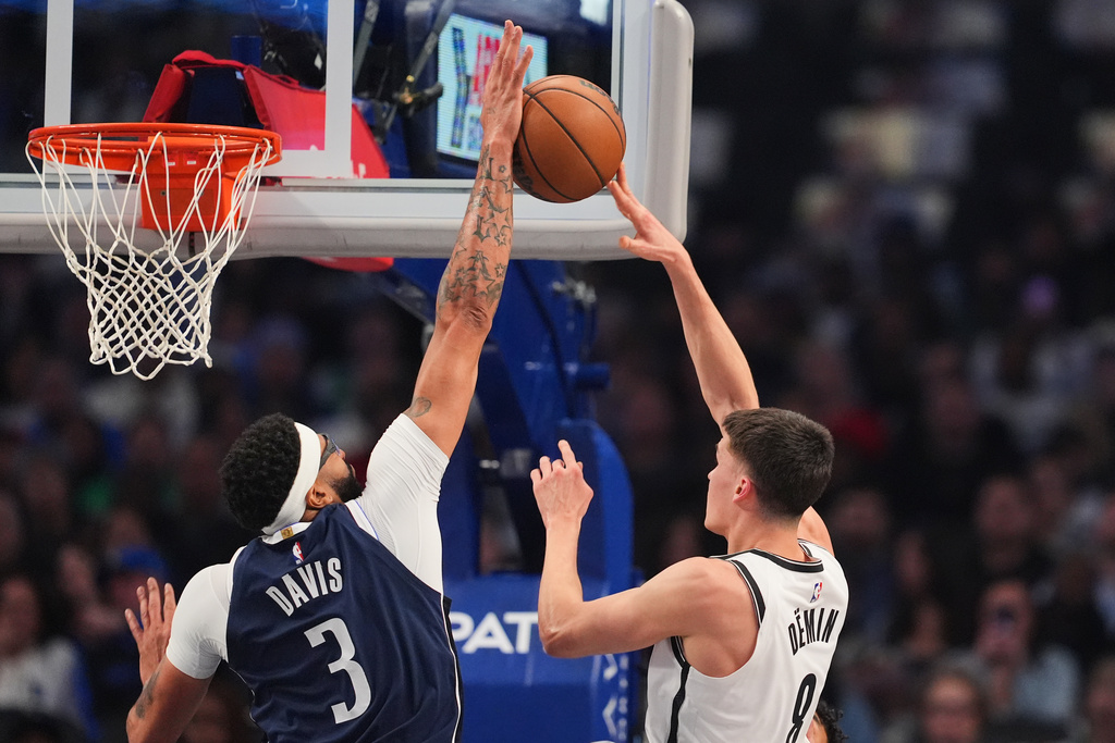 Dallas Mavericks forward Anthony Davis (3) blocks a shot attempt by Brooklyn Nets guard Egor Demin (8) in the first half of an NBA basketball game in Dallas, Friday, Dec. 12, 2025. (AP Photo/Tony Gutierrez)