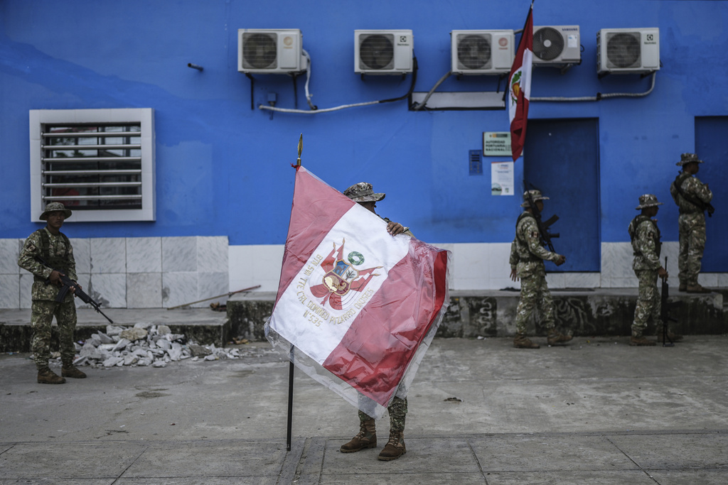 Peruvian soldiers prepare for their morning formation ceremony in Santa Rosa, Peru, an island on the Amazon River at the center of a territorial dispute with Colombia, Sunday, Aug. 17, 2025. (AP Photo/Ivan Valencia)