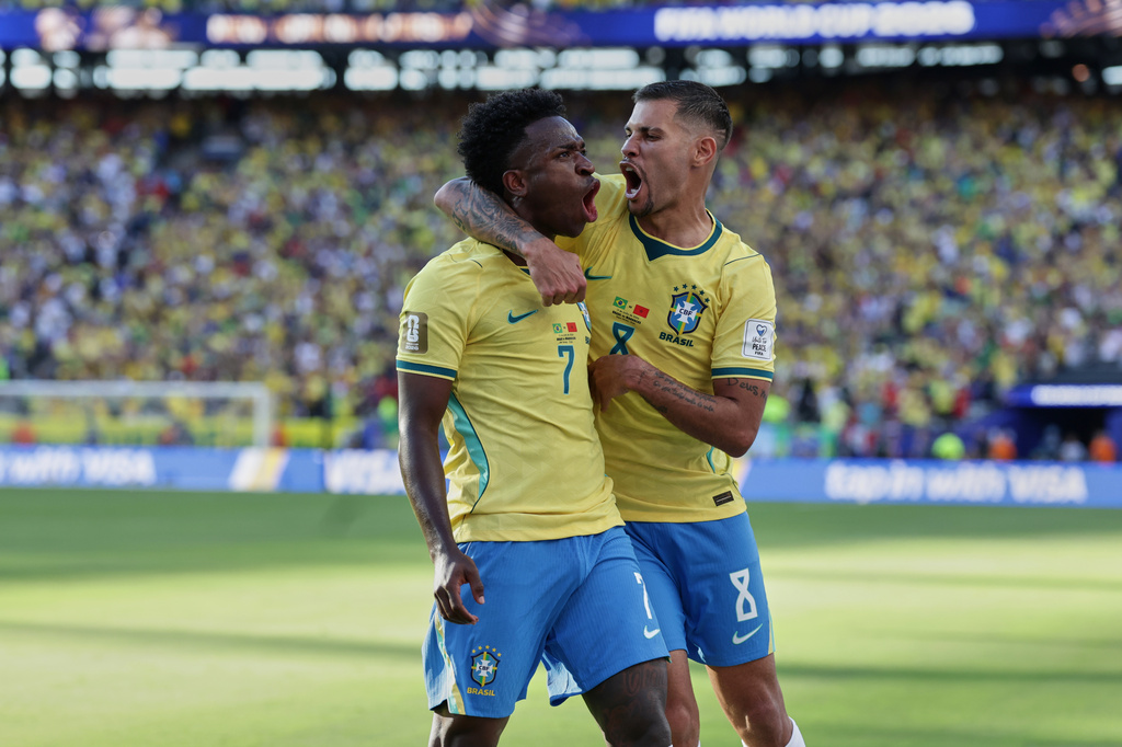 Brazil's Vinicius Junior (7) celebrates with teammate Bruno Guimaraes (8) after scoring during the World Cup Group C soccer match against Morocco in East Rutherford, N.J., near New York, Saturday, June 13, 2026. (AP Photo/Adam Hunger)