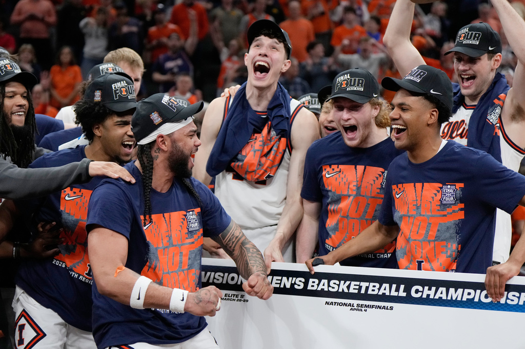 Illinois players celebrate after beating Iowa in an Elite Eight game in the NCAA college basketball tournament Saturday, March 28, 2026, in Houston. (AP Photo/Ashley Landis)