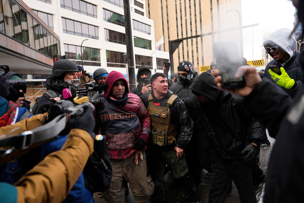 Jake Lang, center in the vest, who organized the March Against Minnesota Fraud, clashes with pro-immigration counterprotesters near Minneapolis City Hall, Saturday, Jan. 17, 2026, in Minneapolis. (AP Photo/Yuki Iwamura)