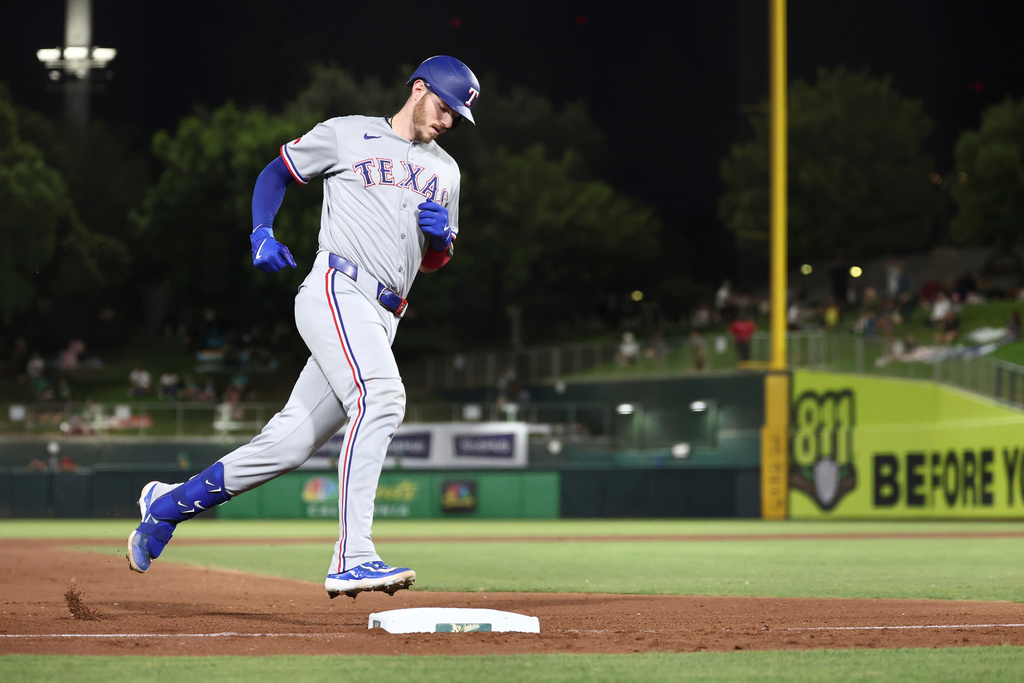 Texas Rangers' Jonah Heim rounds the bases after hitting a solo home run during the fifth inning of a baseball game against the Athletics, Friday, Aug. 29, 2025, in West Sacramento, Calif. (AP Photo/Sara Nevis)