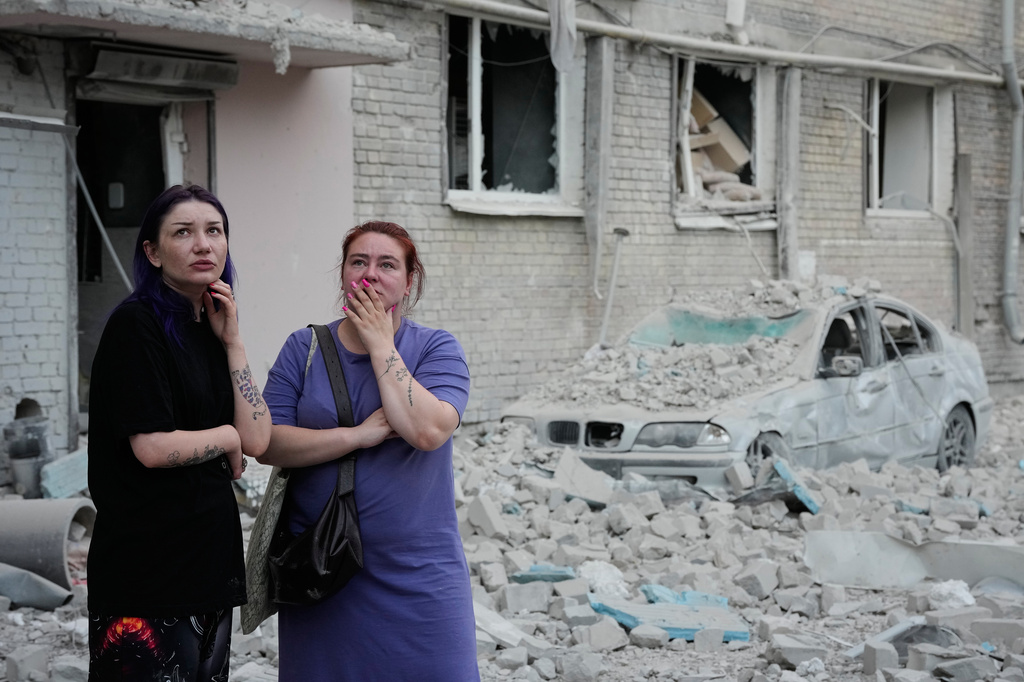 People react at the site of a Russian missile strike that hit a residential building in Kyiv, Ukraine, Thursday, July 2, 2026. (AP Photo/Efrem Lukatsky)