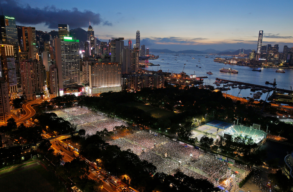 FILE - Tens of thousands of people attend a candlelight vigil to mark the 25th anniversary of Beijing's June 4th Chinese military crackdown on the pro-democracy movement at Victoria Park in Hong Kong on June 4, 2014. (AP Photo/Vincent Yu, File)