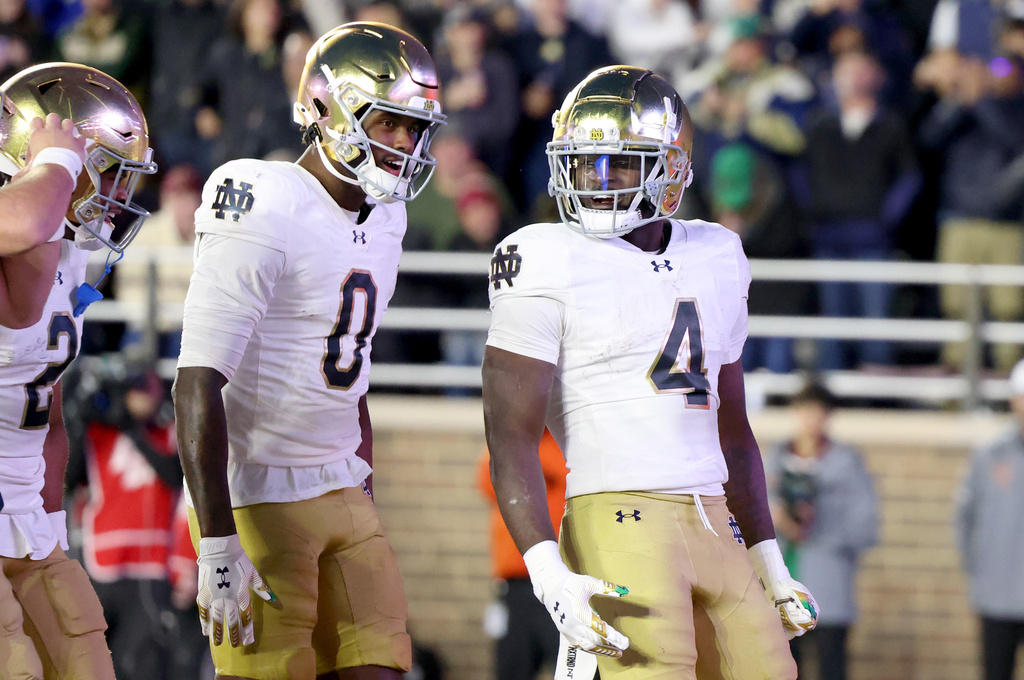 Notre Dame wide receiver Malachi Fields (0) and running back Jeremiyah Love (4) celebrate Love's touchdown during the second half of an NCAA college football game against Boston College, Saturday, Nov. 1, 2025, in Boston. (AP Photo/Mark Stockwell)