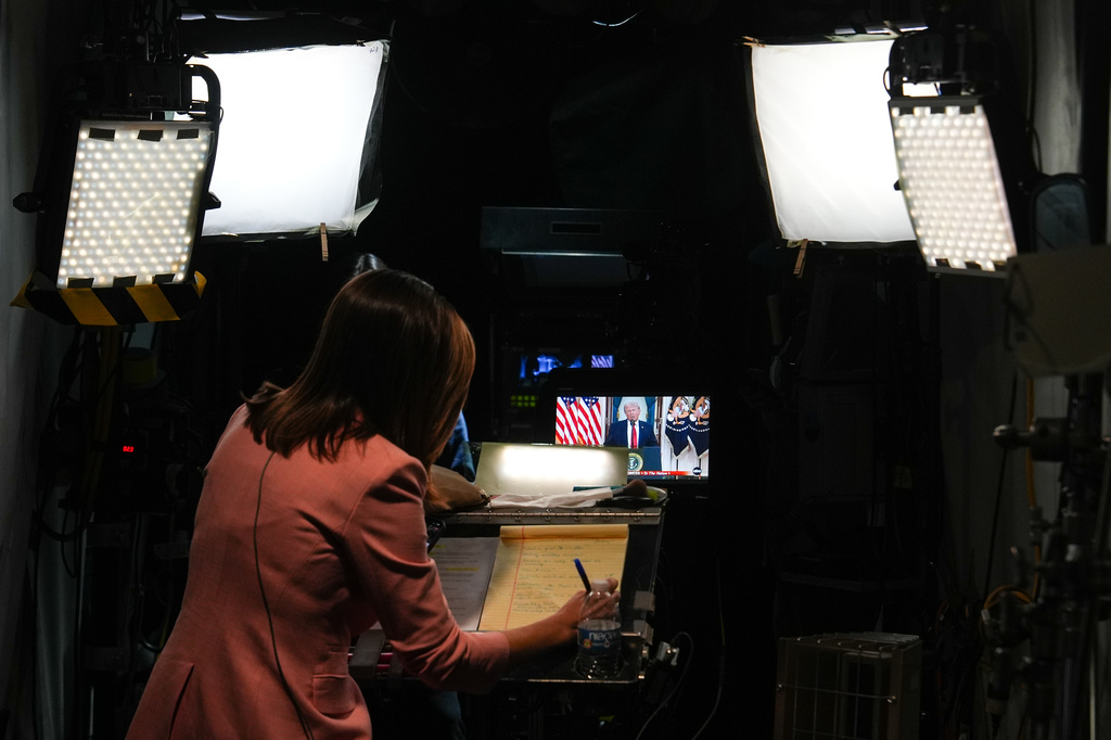 FILE - A journalist prepares for a stand-up as President Donald Trump speaks at the White House, April 1, 2026, in Washington. (AP Photo/Julia Demaree Nikhinson, File)