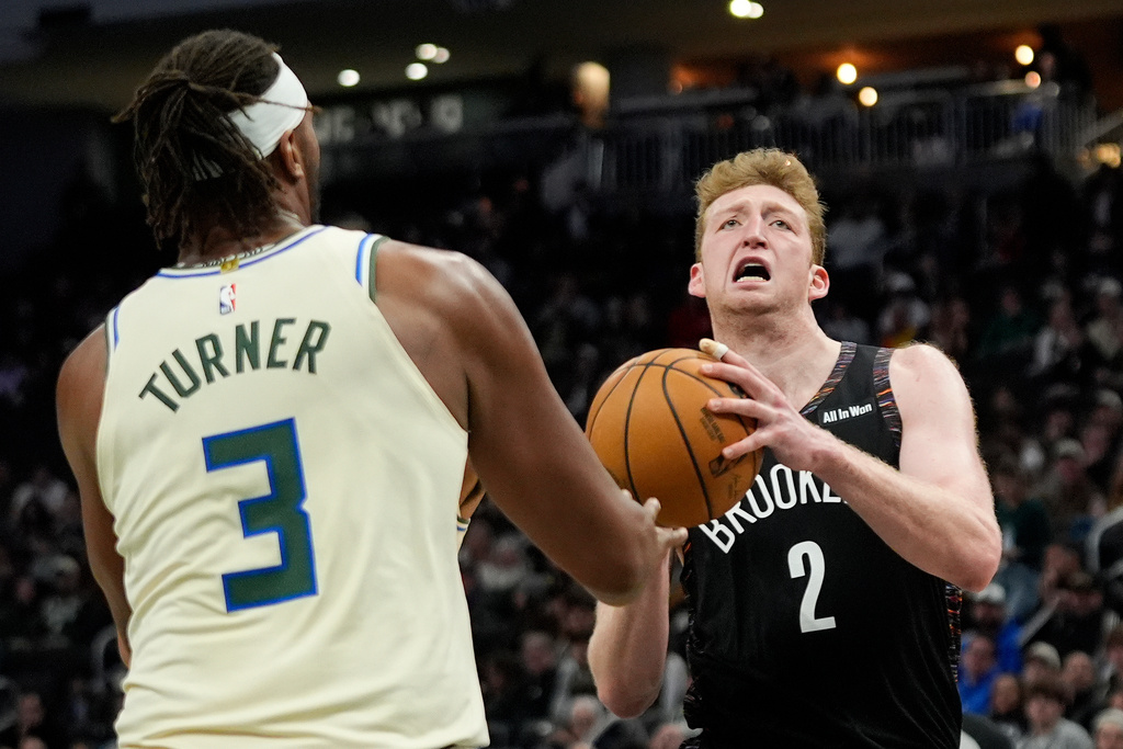 Brooklyn Nets' Danny Wolf (2) drives to the basket against Milwaukee Bucks' Myles Turner (3) during the second half of an NBA basketball game Saturday, Nov. 29, 2025, in Milwaukee. (AP Photo/Aaron Gash)