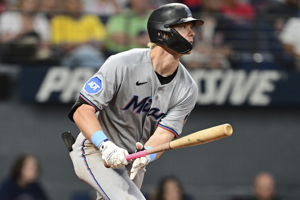 Miami Marlins' Kyle Stowers watches his ball after hitting an RBI single during the sixth inning of a baseball game against the Cleveland Guardians, Wednesday, Aug. 13, 2025, in Cleveland. (AP Photo/David Dermer)