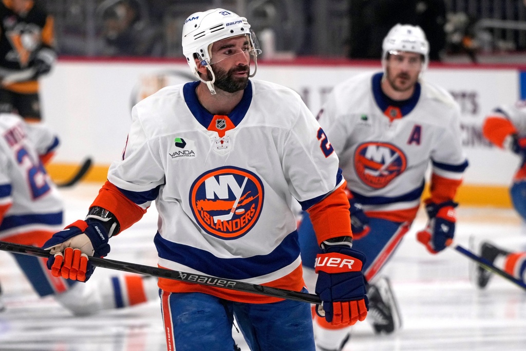 New York Islanders' Kyle Palmieri (21) and Ryan Pulock, right, skated during warm ups before an NHL hockey game against the Pittsburgh Penguins in Pittsburgh, Thursday, Oct. 9, 2025. (AP Photo/Gene J. Puskar)