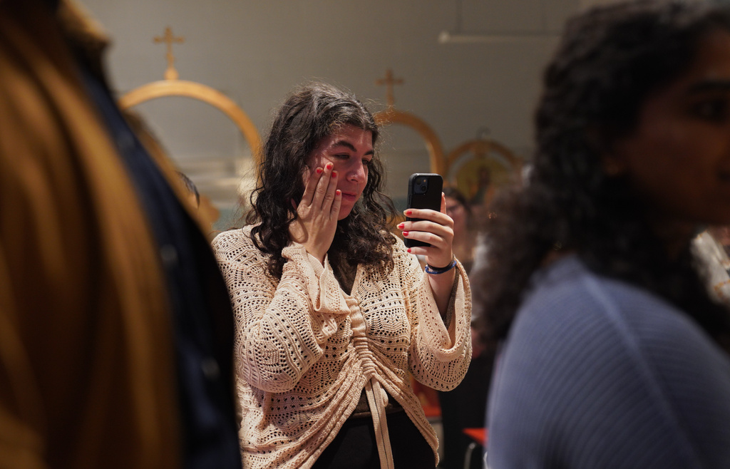 Members of St. Moses the Black Orthodox Church worship together during service on Sunday, Nov. 9, 2025, in Pittsburgh. (AP Photo/Jessie Wardarski)