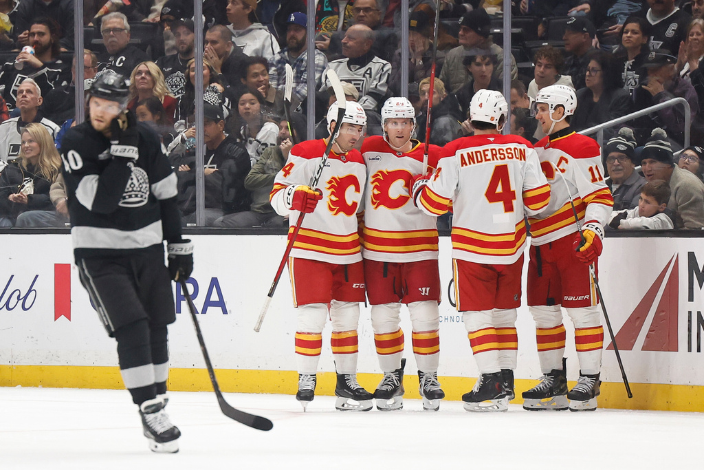 Calgary Flames left wing Blake Coleman (20) is greeted by teammates after scoring during the second period of an NHL hockey game Saturday, Dec. 13, 2025, in Los Angeles. (AP Photo/Caroline Brehman)