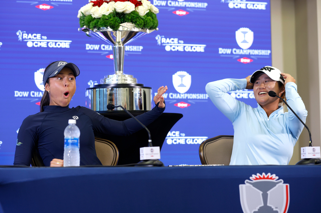 Yana Wilson, left, and Gina Kim react during a press conference after winning the Dow Championship LPGA golf tournament, Sunday, June 14, 2026, at Midland Country Club in Midland, Mich. (AP Photo/Al Goldis)