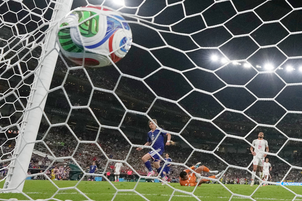Japan's Junya Ito (14) scores their third goal past Tunisia goalkeeper Aymen Dahmen (16) during the World Cup Group F soccer match between Tunisia and Japan in Guadalupe, near Monterrey, Mexico, Saturday, June 20, 2026. (AP Photo/Dolores Ochoa)