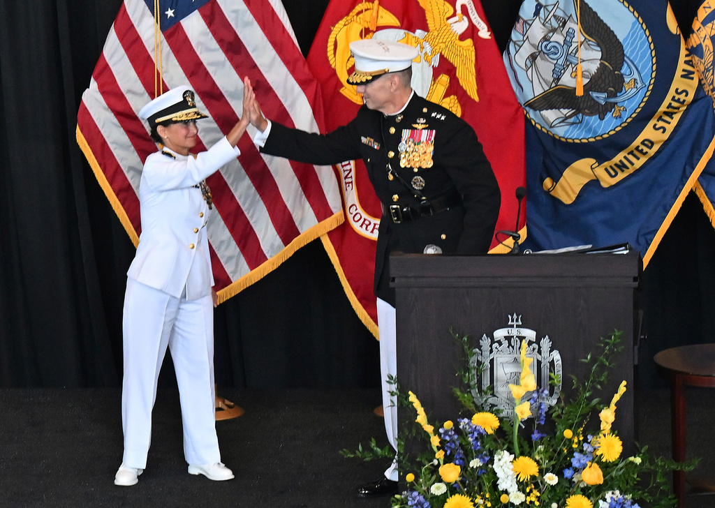Outgoing Superintendent Vice Admiral Yvette M. Davids, U.S. Navy, high fives with new Superintendent Lt. General Michael J. Borgschulte, U.S. Marine Corps. during a Change of Command Ceremony in Annapolis, Md., Friday, Aug. 15, 2025. (Paul W. Gillespie/Capital Gazette via AP)