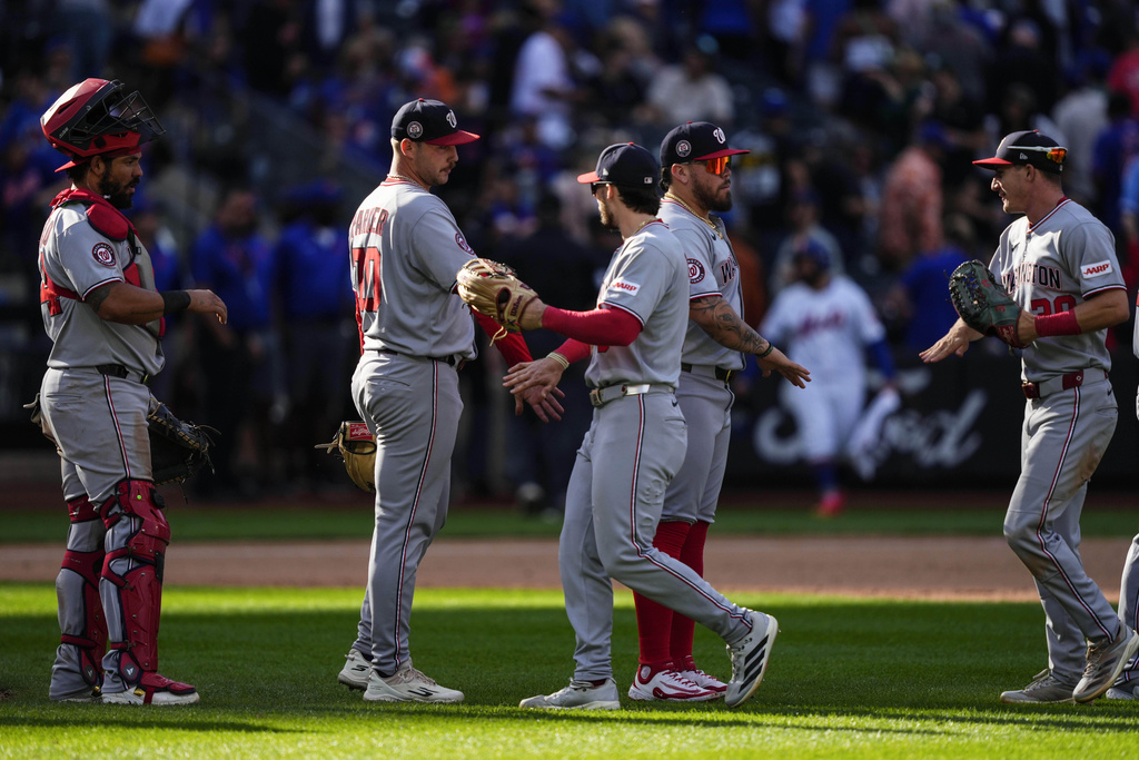 Players of Washington Nationals celebrate after winning a baseball game against the New York Mets, Sunday, Sept. 21, 2025, in New York. (AP Photo/Yuki Iwamura)