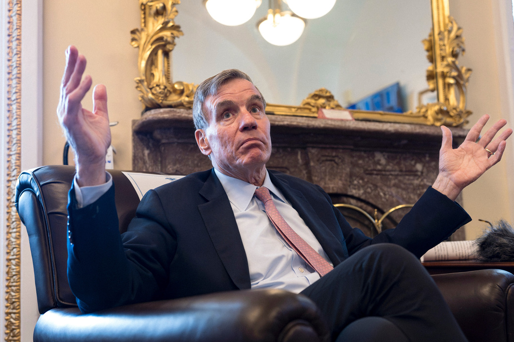 Sen. Mark Warner, D-Va., the vice chair of the Senate Intelligence Committee, speaks to reporters about FISA, the law that allows the U.S. to gather intelligence abroad, at the Capitol in Washington, Thursday, June 11, 2026. (AP Photo/J. Scott Applewhite)