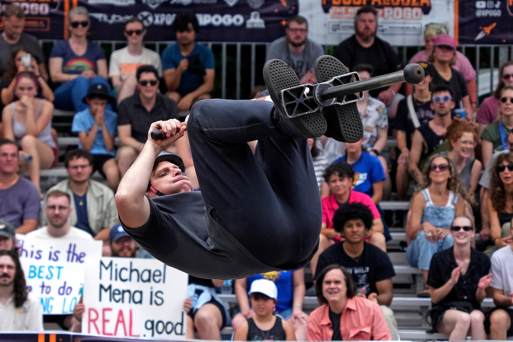 Extreme pogo athlete Michael Mena does a back flip during his first place effort during the Big Air competition at Pogopalooza 2026 in Wilkinsburg, Pa., Sunday, June 14, 2026. (AP Photo/Gene J. Puskar)